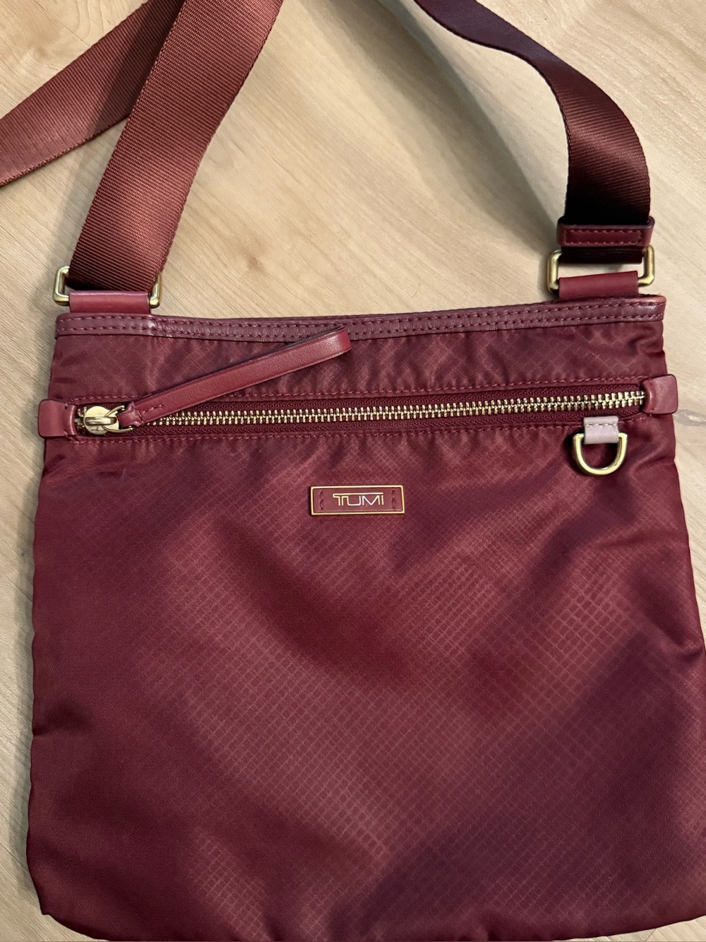 Tumi Burgundy Crossbody Bag with Gold-Tone Details